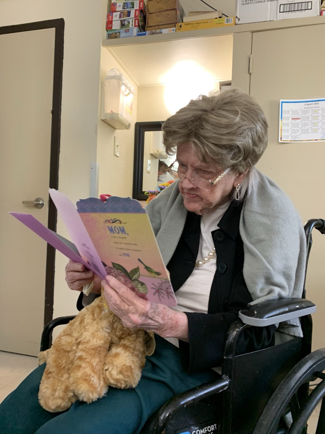 A resident reading a greeting delivered by our activities team